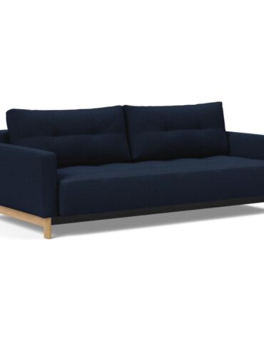 blaues Klappsofa mit Kissen und Holzbeinen