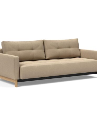 beiges Klappsofa mit Kissen und Holzbeinen